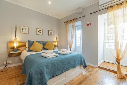 a bedroom with a bed with towels on it at Lisbon Core Apartments Bairro Alto in Lisbon