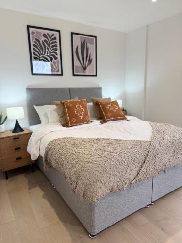 a bedroom with a bed with two pillows on it at New build - king bed - Fast Wi-Fi - Zone 2 in London