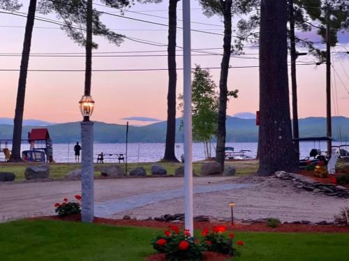 a street light in a park with the ocean in the background at The Tinker Bell on Ossipee Lake in Ossipee