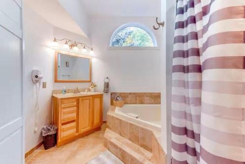 a bathroom with a tub and a sink and a bath tub at Lake and Ski Escape with Hot Tub Coming Soon in Lake Harmony
