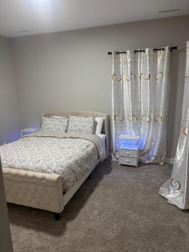 a bedroom with a bed and curtains in it at 1st Luxury Residential Elevator rooftop deck in Rochester