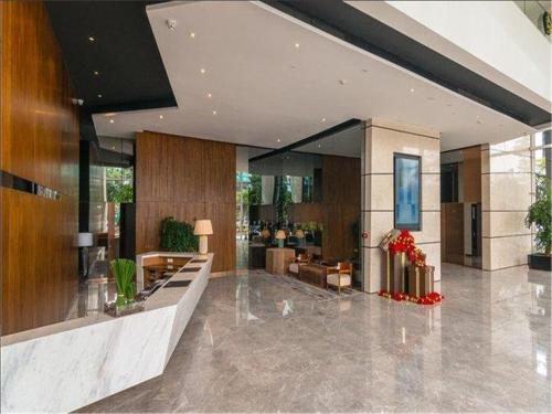 a lobby of a building with a large lobby at The Summit Hotel in Zhongshan