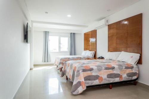 Krevet ili kreveti u jedinici u okviru objekta Suites Gaby Cancun