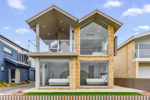 a house with two beds inside of it at Aloha Beachfront Port Fairy in Port Fairy