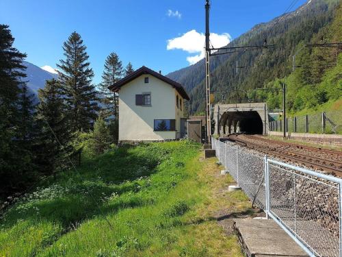 a train station next to a tunnel in a mountain at Eggwald in Wassen