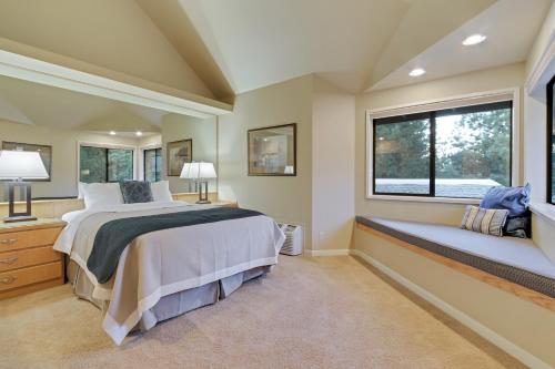 a bedroom with a large bed and two windows at River Ridge 428B - Meredith Lodging in Bend