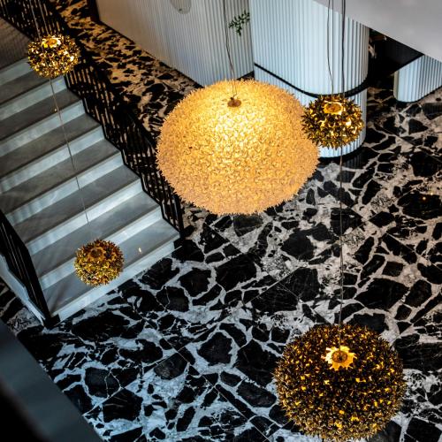a lobby with a black and white marble floor and chandeliers at Z Hotel Sfax in Sfax