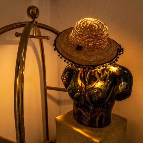 a statue of a person wearing a hat next to a lamp at Z Hotel Sfax in Sfax