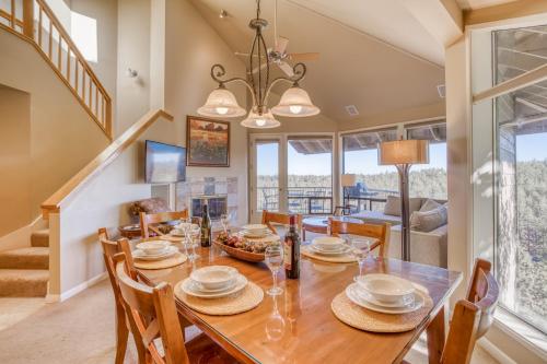 a dining room and living room with a table and chairs at River Ridge 425A - Meredith Lodging in Bend