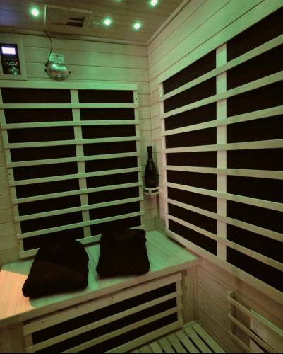 a room with a bench with two pillows on it at La Bulle de Velours in Bouguenais