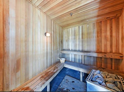 an empty wooden sauna with a tub in it at Sea-view apartment in the heart of Gold Coast in Gold Coast