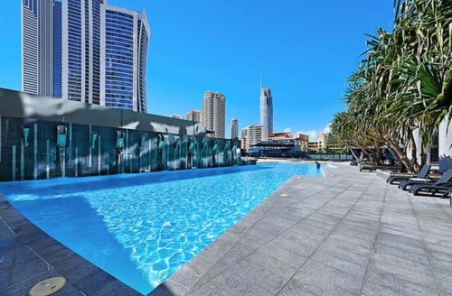 a swimming pool with a city skyline in the background at Sea-view apartment in the heart of Gold Coast in Gold Coast