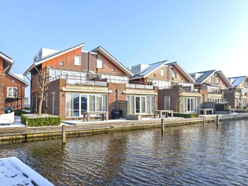 a row of houses next to a body of water at Appartement Assum I in Uitgeest