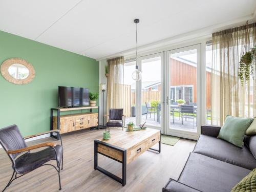 a living room with a couch and a table at Lakehouse I in Uitgeest