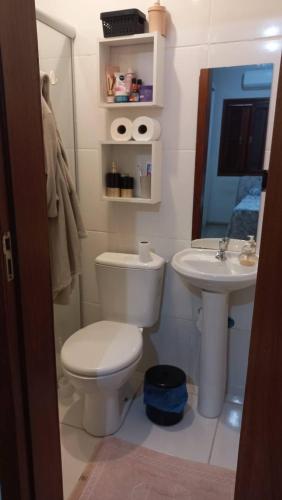 a bathroom with a toilet and a sink at Casa da Carmem in São Gabriel