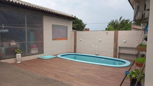a swimming pool in the backyard of a building at Casa da Carmem in São Gabriel