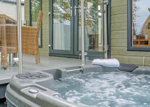 a jacuzzi tub in front of a house at Bainbridge Ings in Hawes
