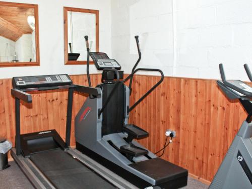 a treadmill in a room with a mirror at The Granary Cottage in Warenford