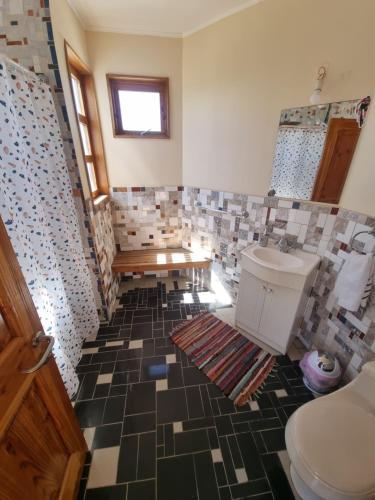 a bathroom with a toilet and a sink at Pedal Paradise Tongoy in Tongoy