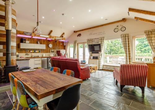 a kitchen and living room with a wooden table and chairs at Durham Coastal Lodges in Haswell