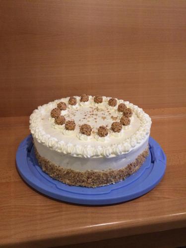 a cake sitting on a blue plate on a table at Gasthof Bader in Deutsch Goritz