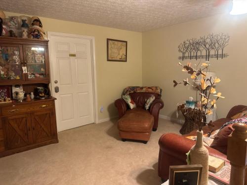 a living room with a couch and a chair at serenity hill bed and breakfast in Brownsville