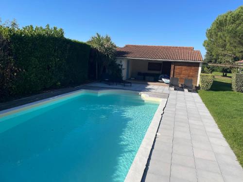 a swimming pool in front of a house at Modern Villa with Pool in Brives in Brives-sur-Charente
