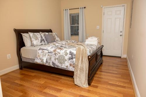 a bedroom with a bed and a wooden floor at CityStay in Baltimore