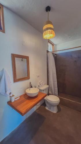 a bathroom with a sink and a toilet at Kinti Beach Mancora in Máncora