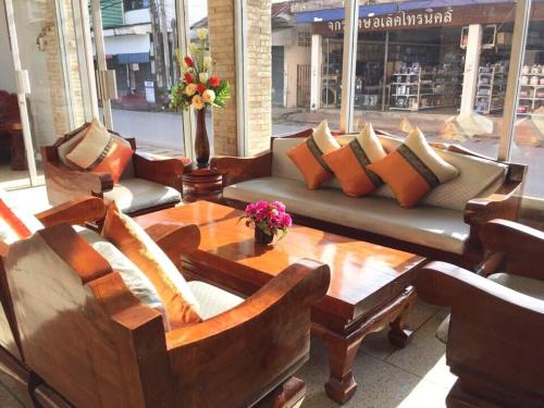 a living room with a couch and a table at Mitaree Hotel 1 in Mae Sariang