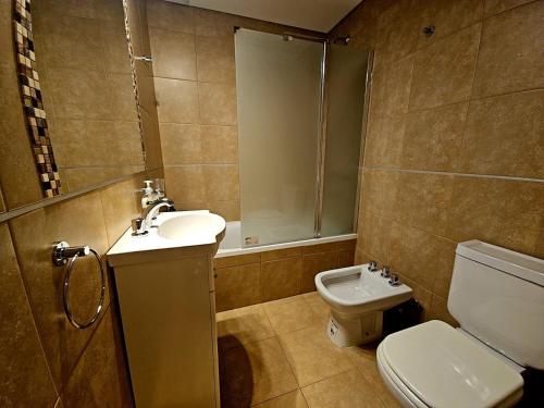 a bathroom with a sink and a toilet and a shower at Departamento Studio 20 - Rio Grande - Tierra del Fuego in Río Grande