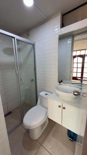 a bathroom with a toilet and a sink and a shower at Habitación con Balcón Castellares La Puebla in Ayacucho