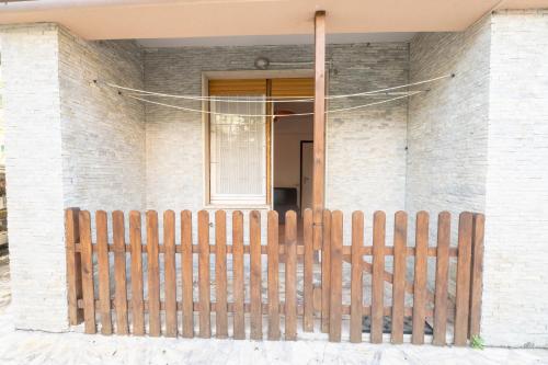 a wooden fence in front of a house at 325 - Casa Pede a Deiva Marina - 300metri dalla Spiaggia e dal Mare e dal Centro Storico in Deiva Marina