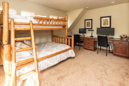 a bedroom with bunk beds and a desk with a computer at Secluded Golf Course Retreat with Firepit, EV Charging, and Ultimate Privacy in Roslyn
