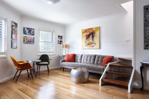 a living room with a couch and a table and chairs at Darlington Hideaway - Close to everything in Sydney