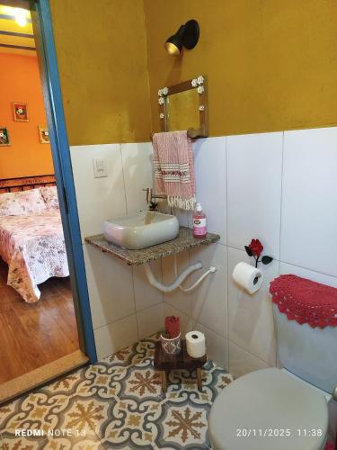 a bathroom with a sink and a toilet at Chalé Catarina Mendes in Ouro Preto