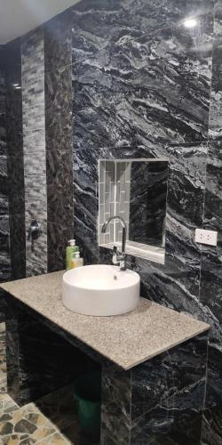 a bathroom with a sink and a mirror at birdwatchers beachfront hotel panglao in Panglao Island