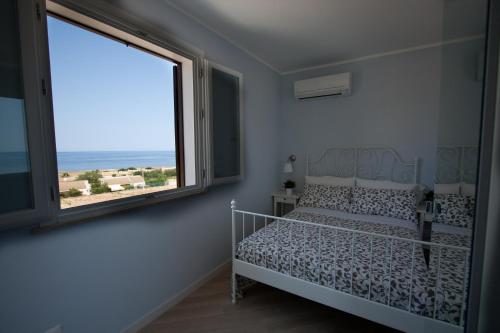 Ένα ή περισσότερα κρεβάτια σε δωμάτιο στο Un mare di Blu - Casa Cobalto