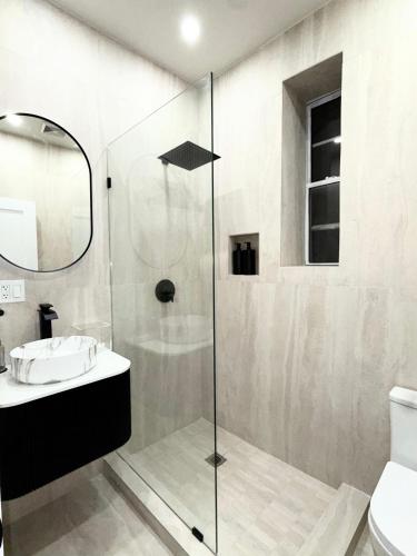 a bathroom with a shower with a sink and a toilet at The View - Direct Bus Time Square NYC Breakfast Included - A in Jersey City