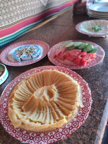 a table with plates of food on top at Wadi rum view camp in Wadi Rum
