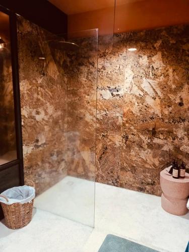 a bathroom with a glass shower with a toilet at Motel LOVE SONG Canggu in Canggu