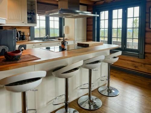 Una cocina con una encimera con taburetes. en Family Cabin With Panoramic Views In Aurdalsåsen, en Aurdal