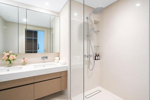 a bathroom with a shower and a sink at Pure Voyage Beachfront in Dubai