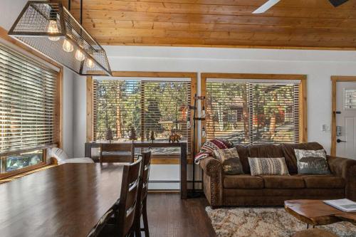 a living room with a table and a couch at Cabin 3- Cozy updated cabin 5 min to RMNP in Estes Park