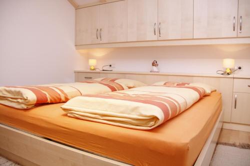 two beds in a kitchen with white cabinets at Residence Wiesenheim in Trodena