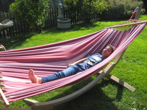 a young child laying in a hammock at Residence Wiesenheim in Trodena