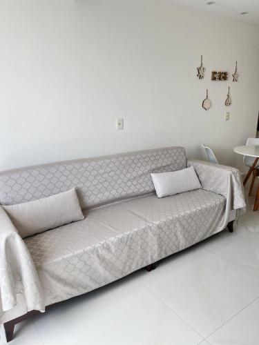 a couch with two pillows on it in a room at Cobertura Ponta Verde Vistar Mar in Maceió