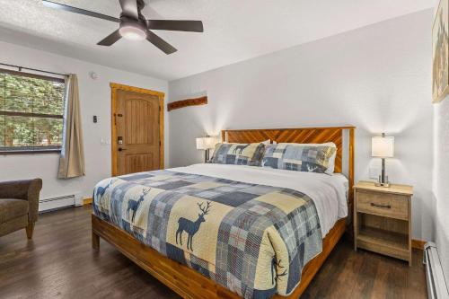 a bedroom with a bed and a ceiling fan at Cabin 14 - King Bed hotel-style unit in Estes Park