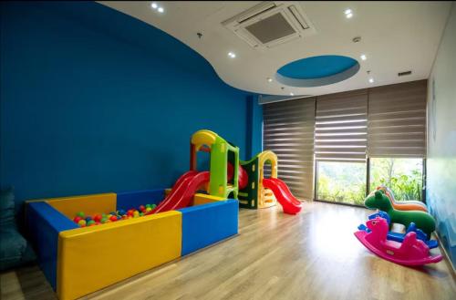 a childrens play room with a slide and play equipment at La paix home 3BR Lakefront Apartment with Balcony and Free Onsen in Kim Quan