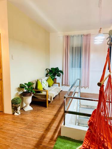 a living room with a couch and a staircase at The ComfyNook Hostel in Santa Maria